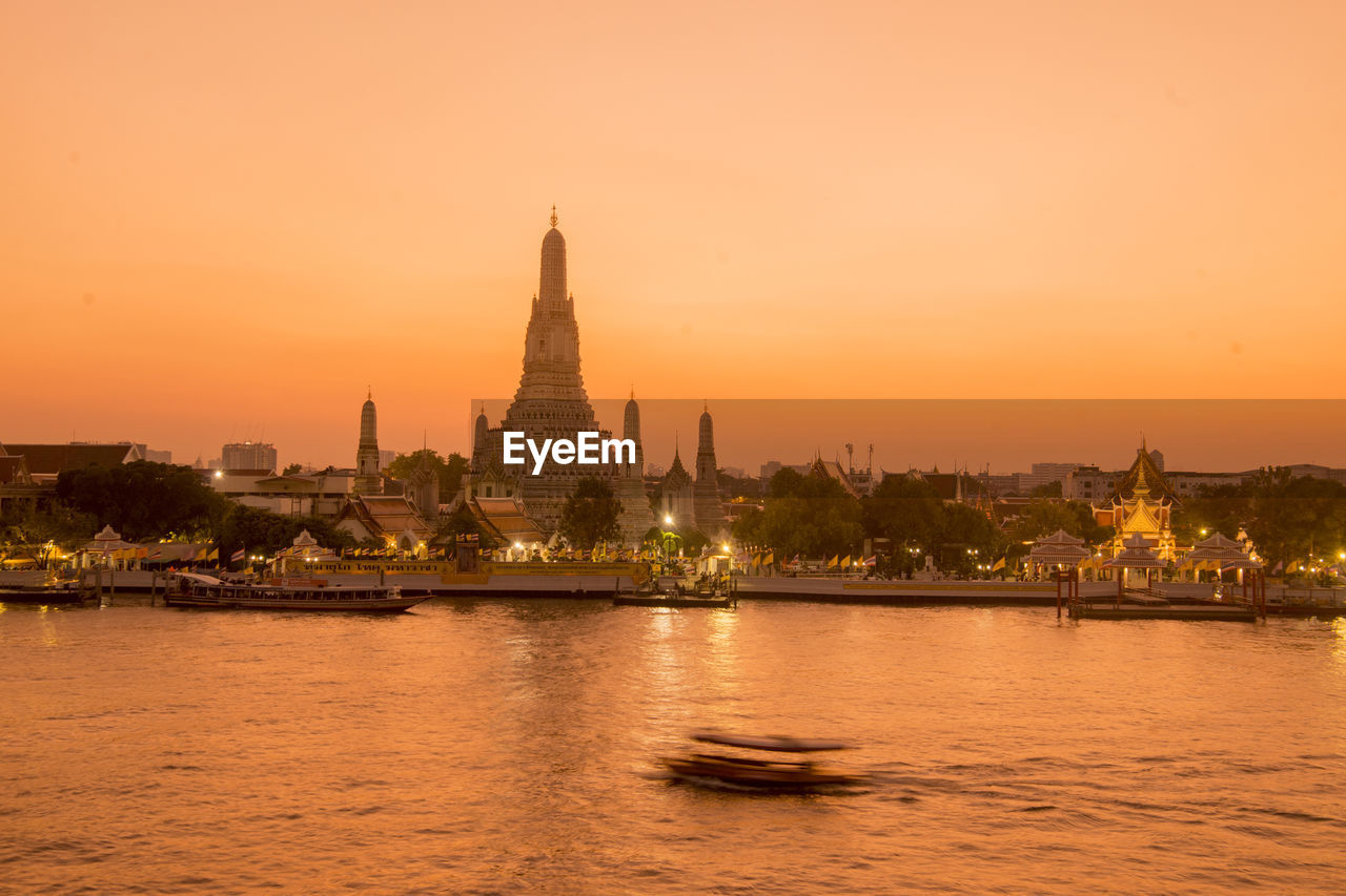 VIEW OF ILLUMINATED BUILDINGS AT SUNSET