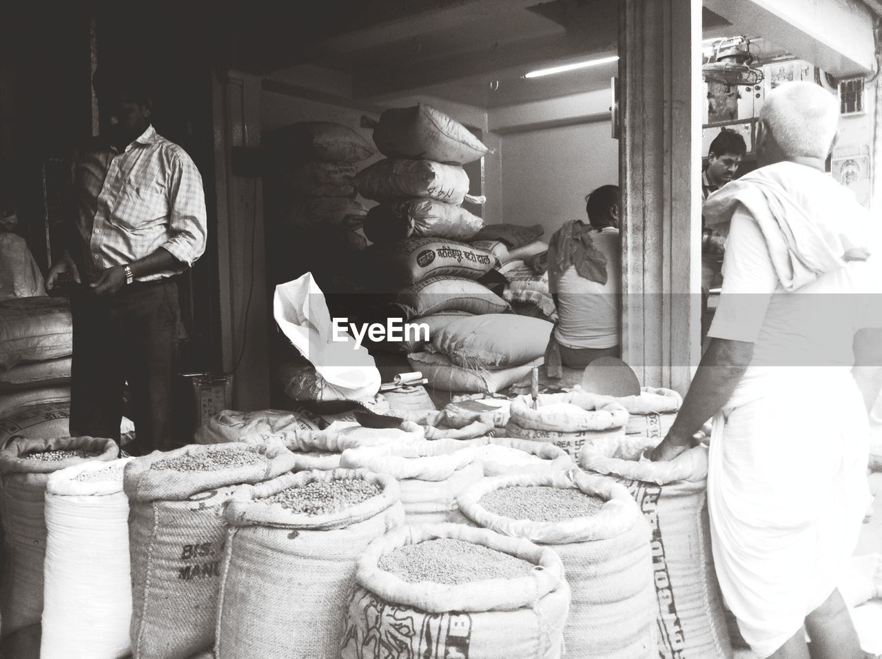 PEOPLE IN MARKET STALL