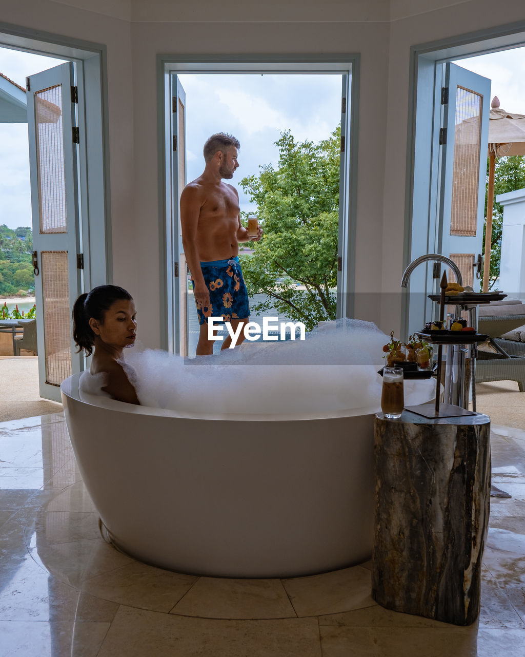 side view of woman sitting in bathroom at home