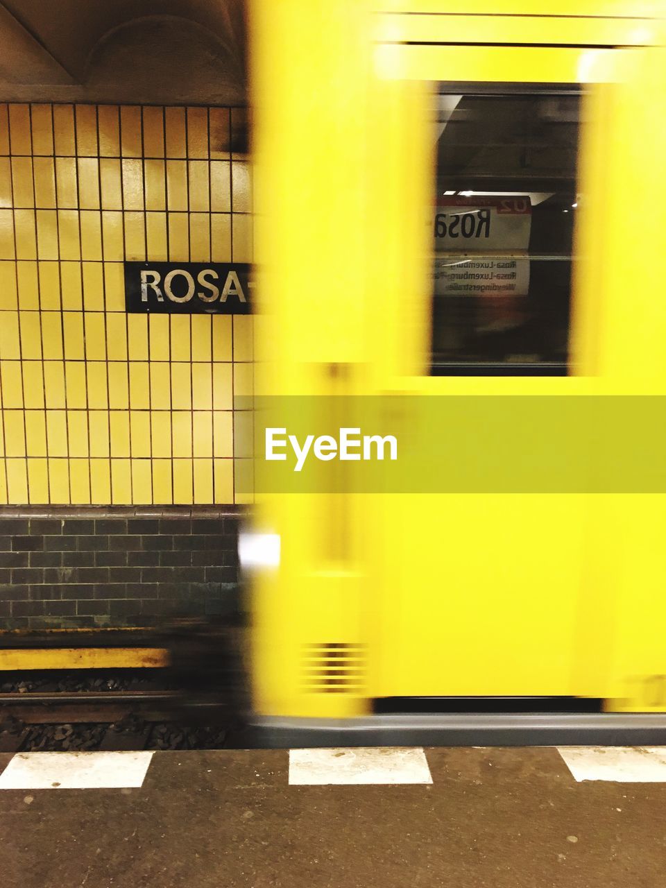 Blurred motion of yellow train at subway station