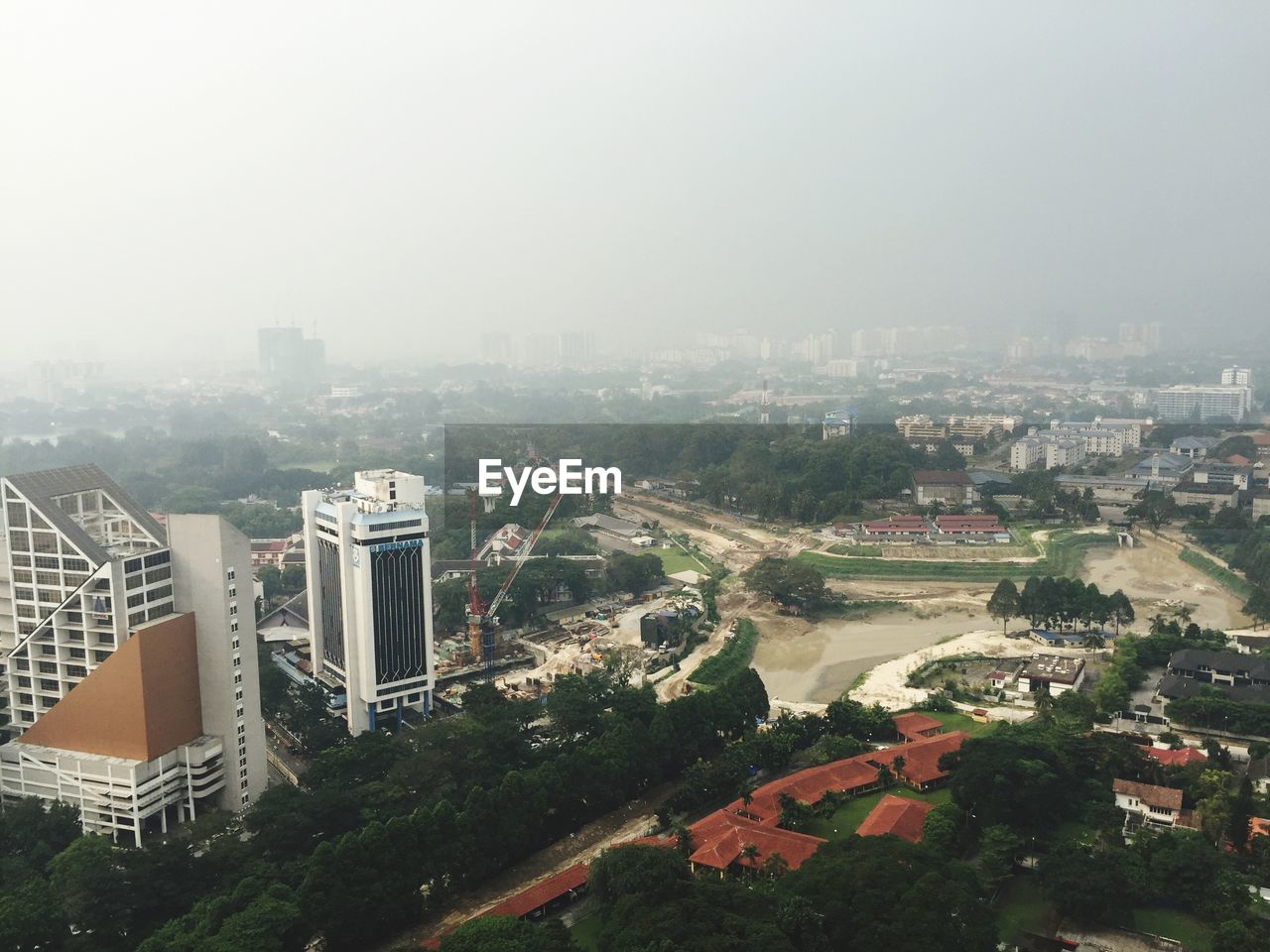 Aerial view of cityscape during foggy weather
