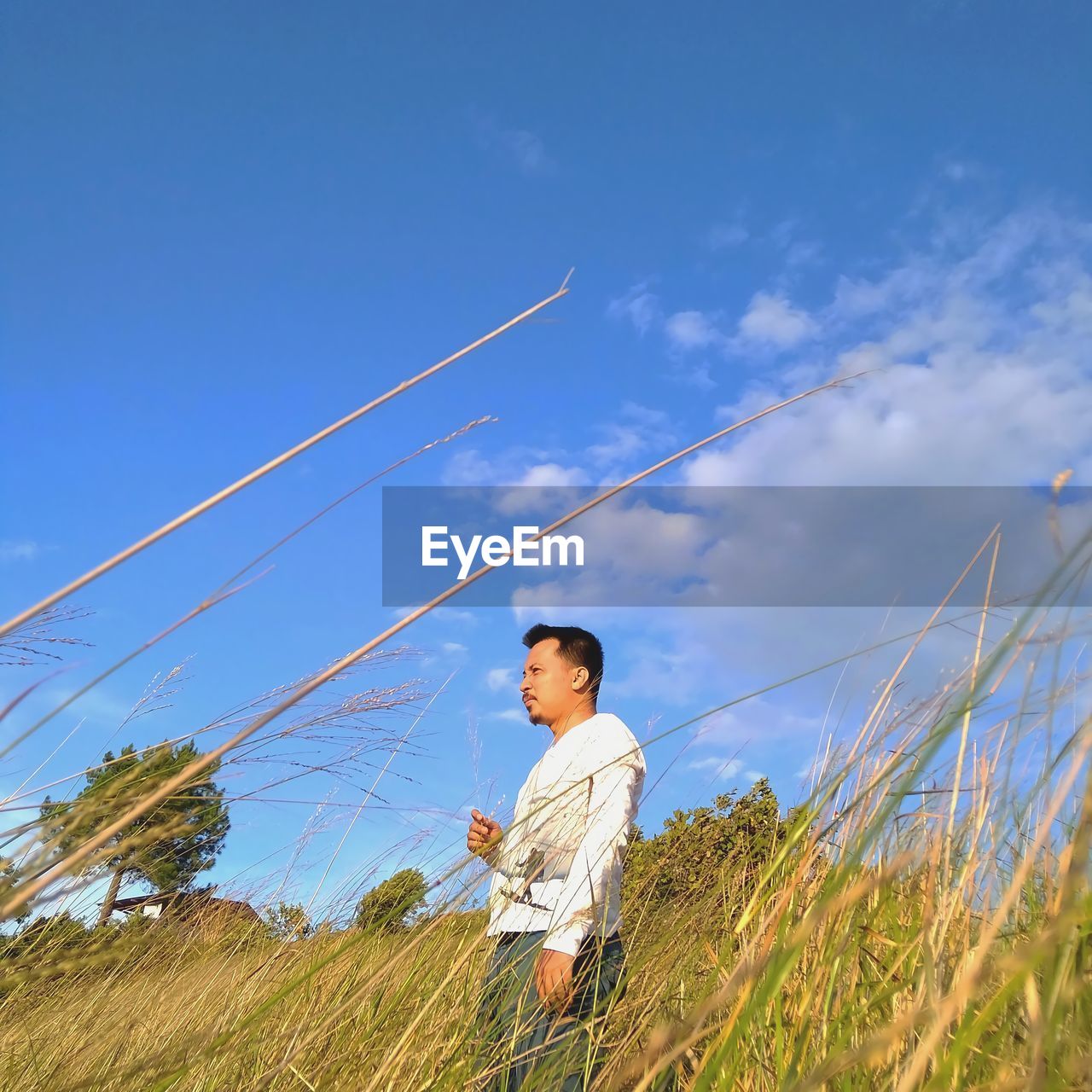 Man standing on field against sky