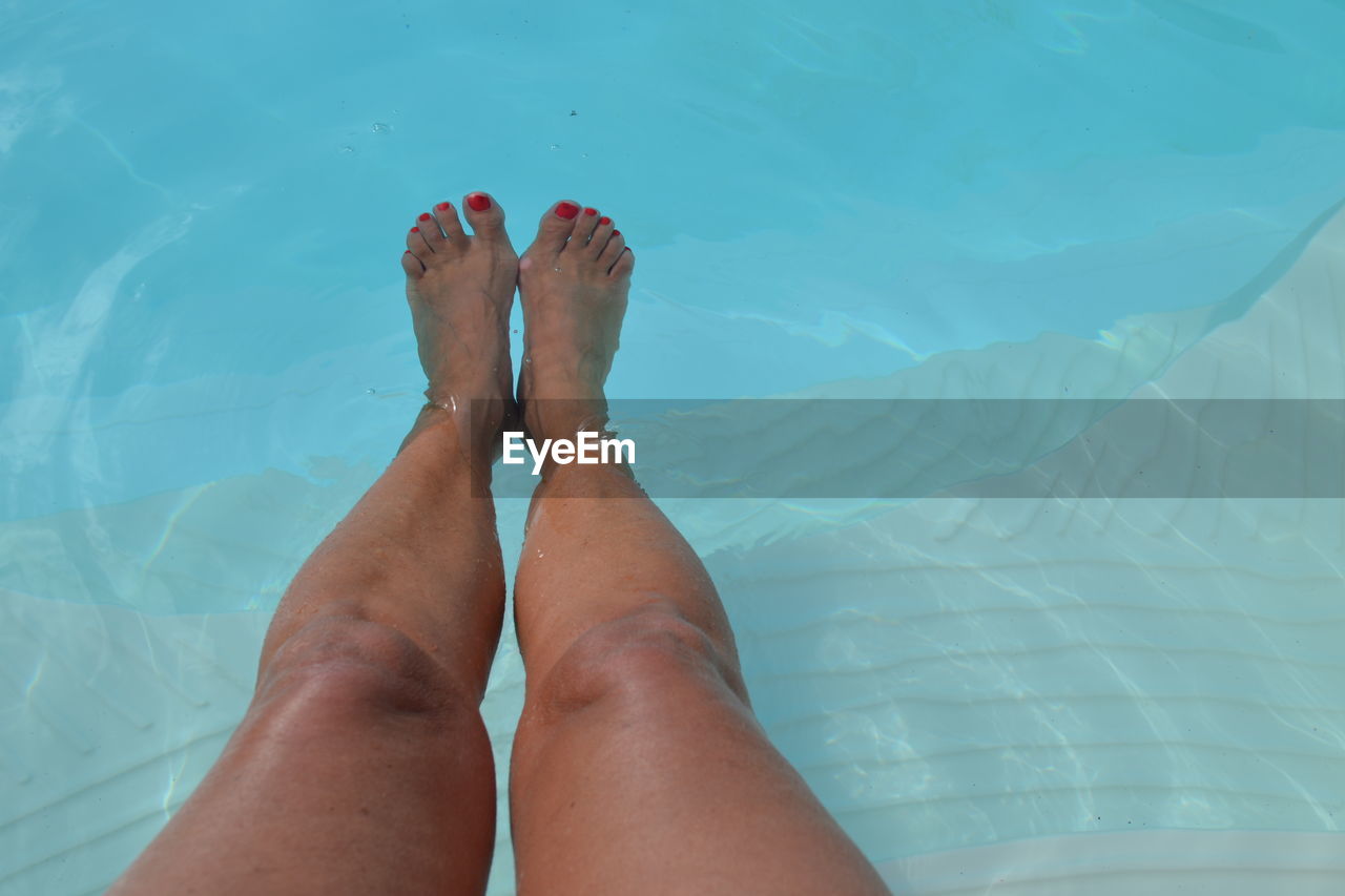 Low section of woman in swimming pool