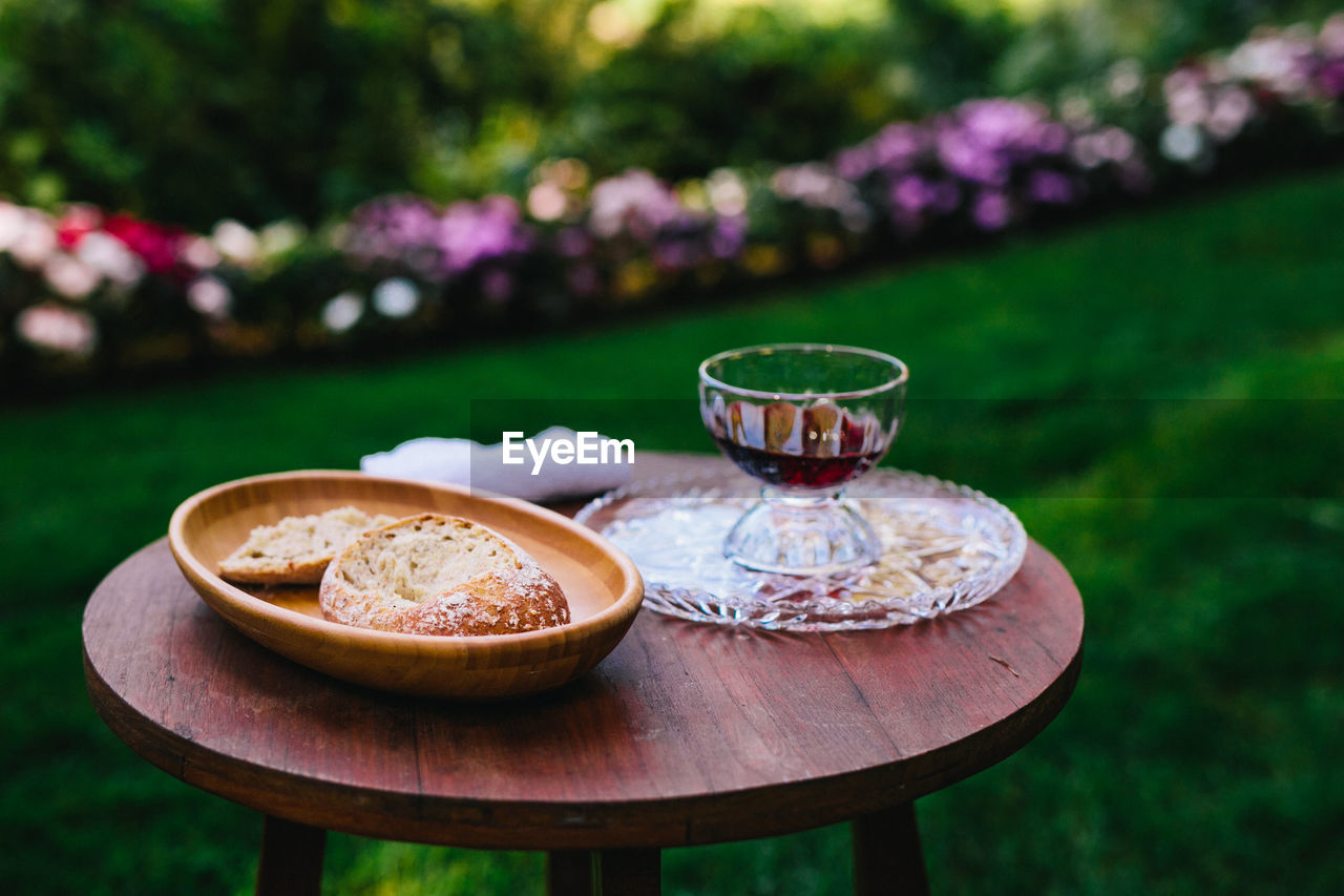 Close-up of food and drink on table in yard