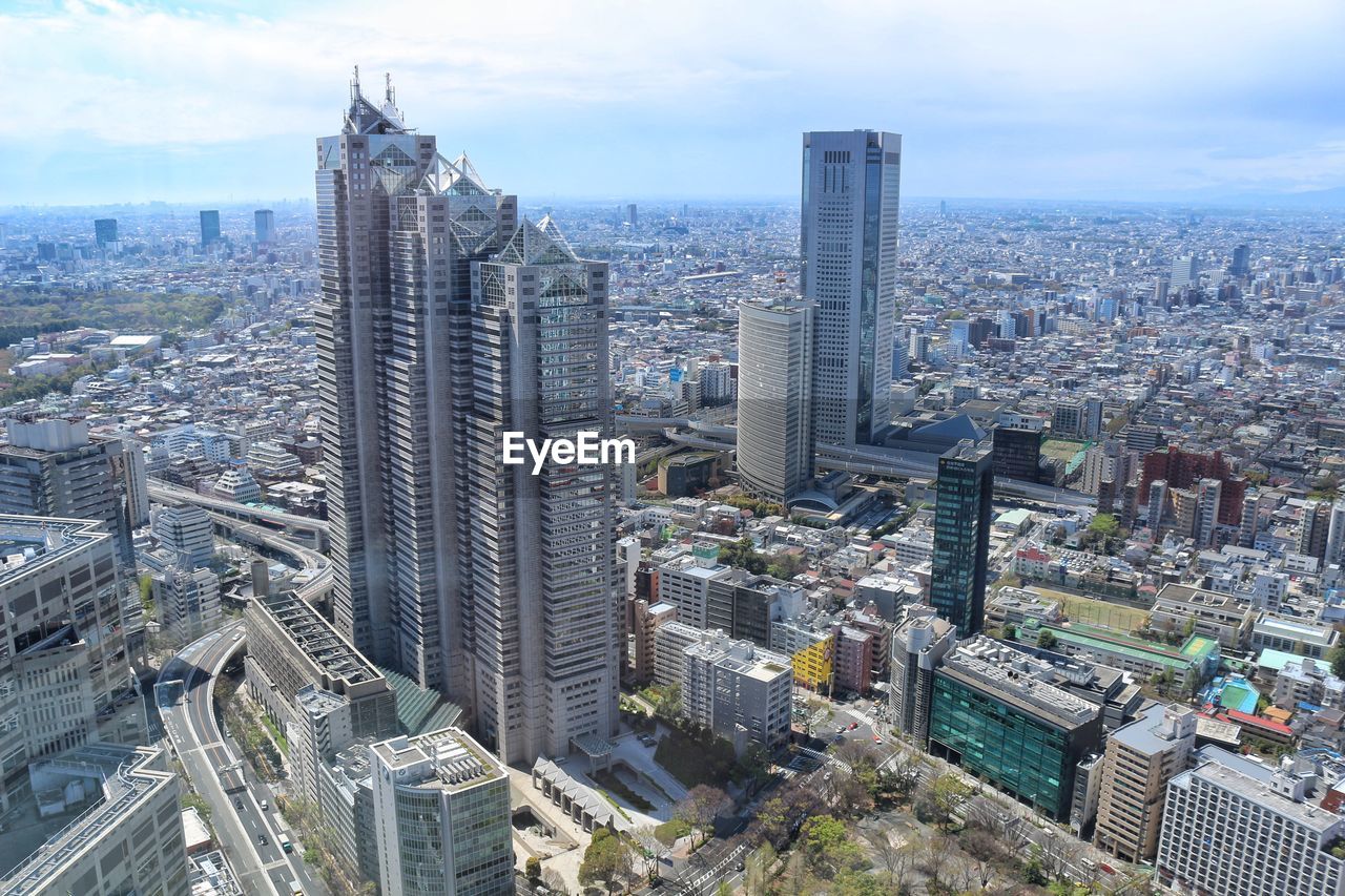 High angle view of modern buildings in city against sky