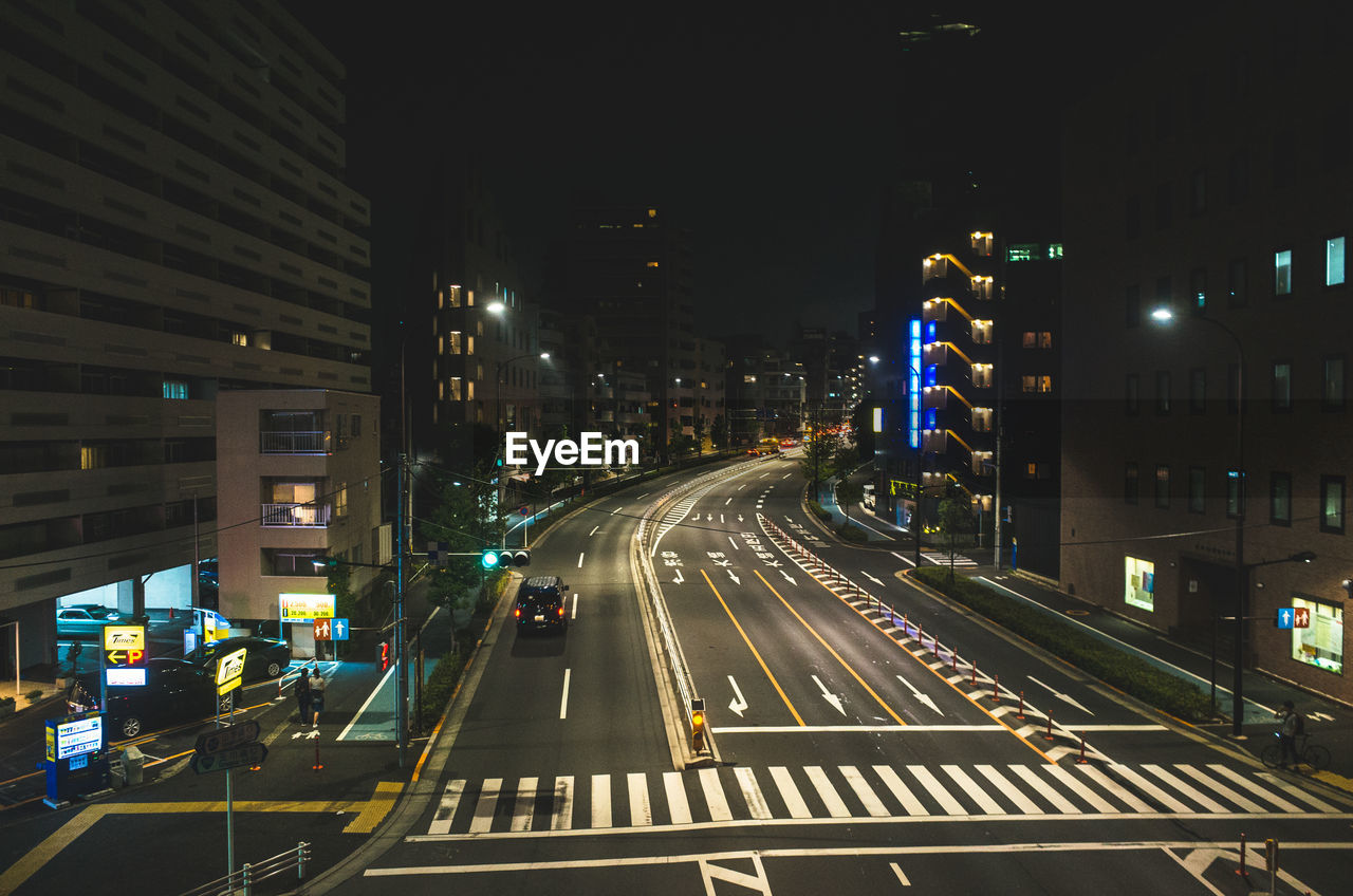 ILLUMINATED LIGHT TRAILS ON ROAD AT NIGHT