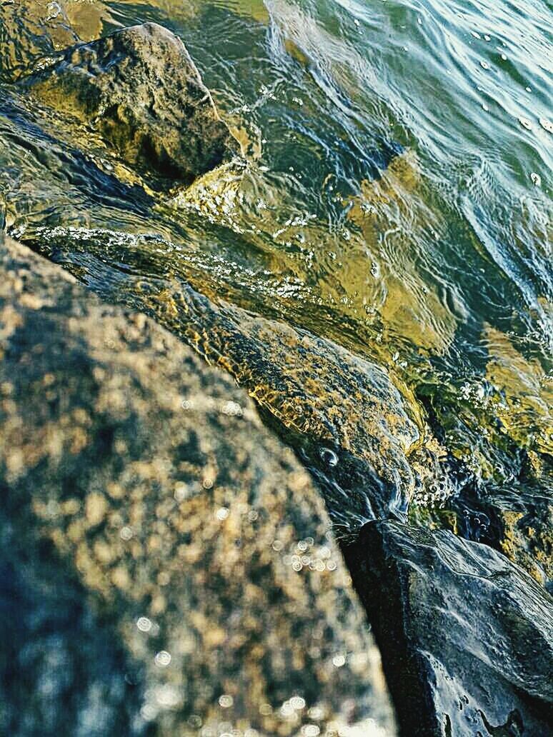 High angle view of rocks at sea shore