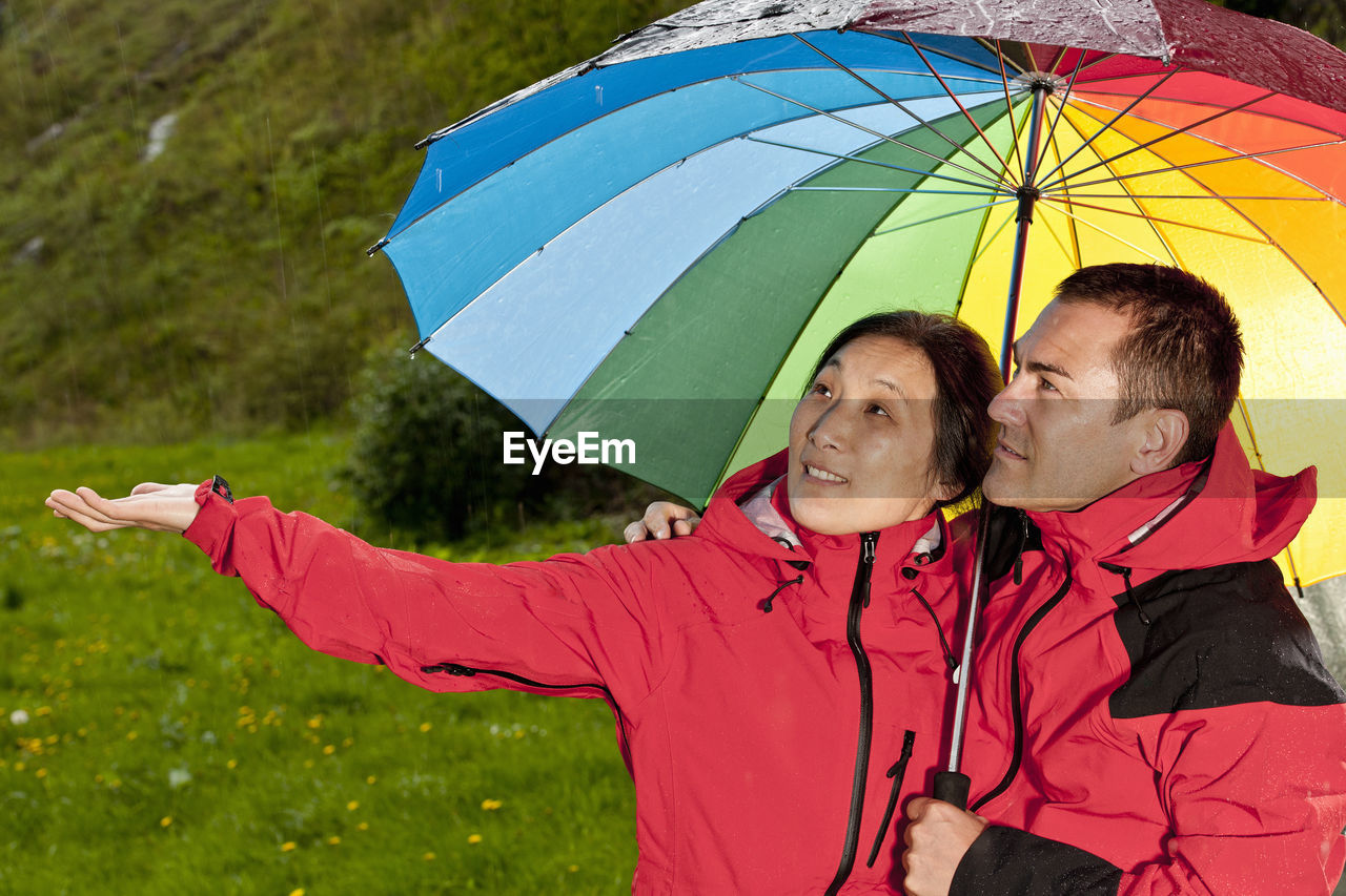 Couple enjoying a walk in the rain in england