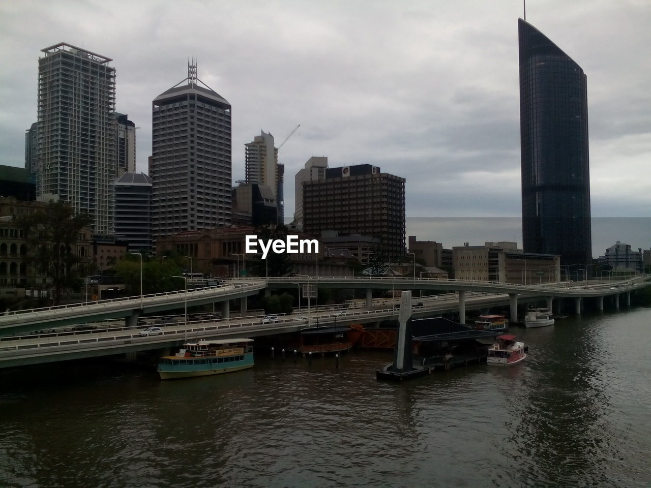 BOATS IN RIVER IN CITY