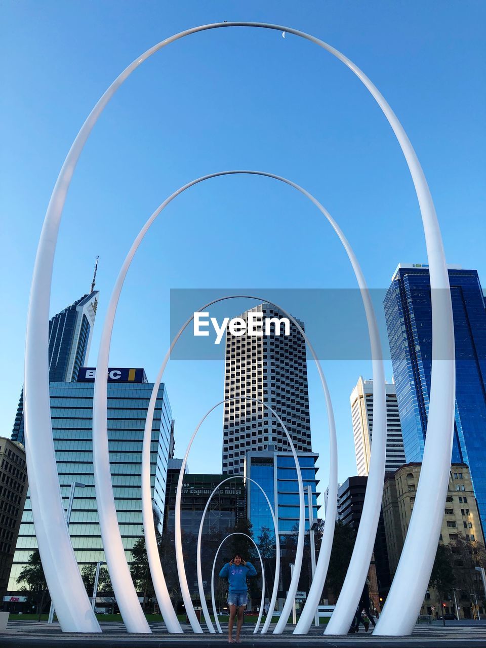 MODERN BUILDINGS AGAINST CLEAR BLUE SKY IN CITY