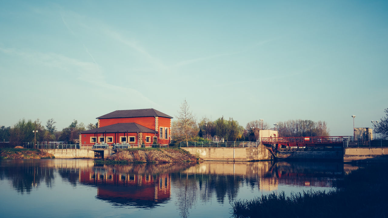 View of river and house against sky