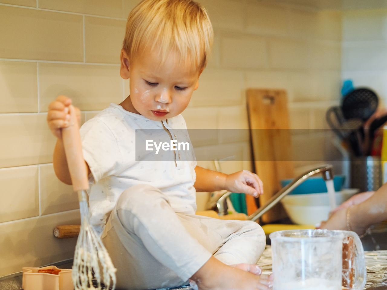 Cute boy preparing food at kitchen