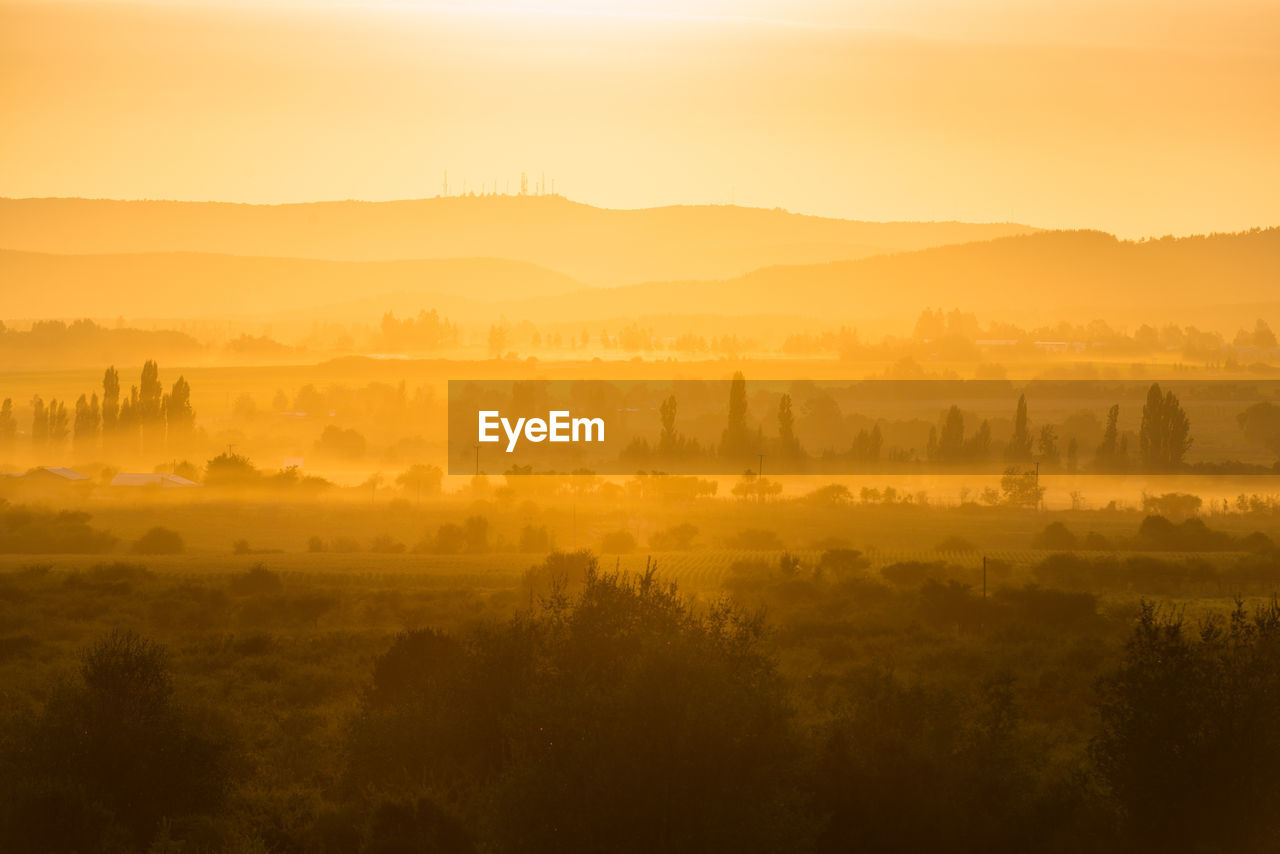 Scenic view of landscape against sky during sunset