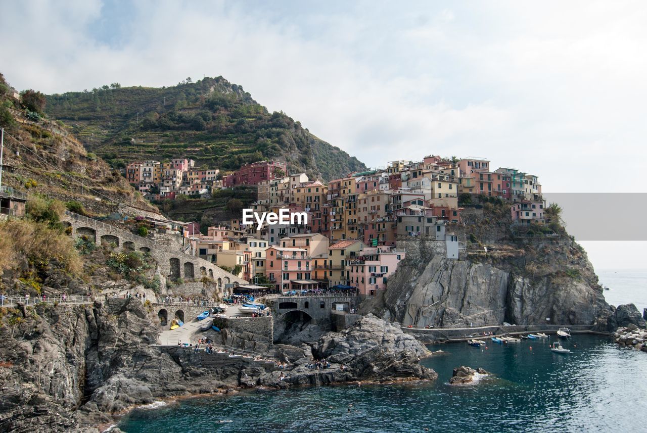 Panoramic view of cliff by sea against sky