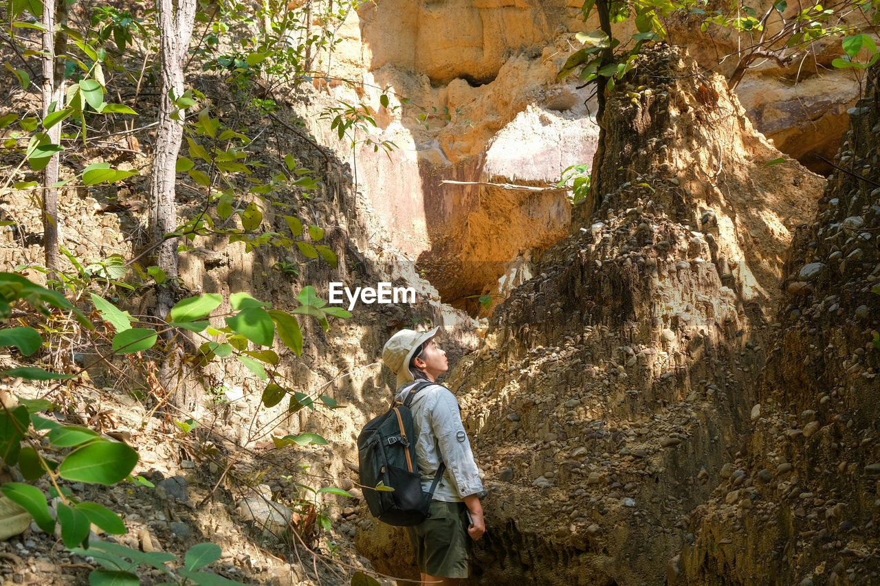 rear view of man standing on rock