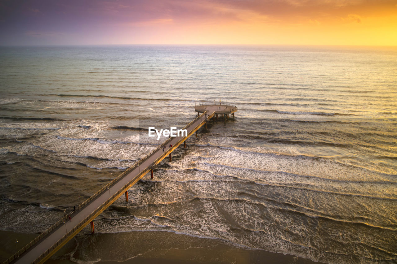 SCENIC VIEW OF BEACH DURING SUNSET