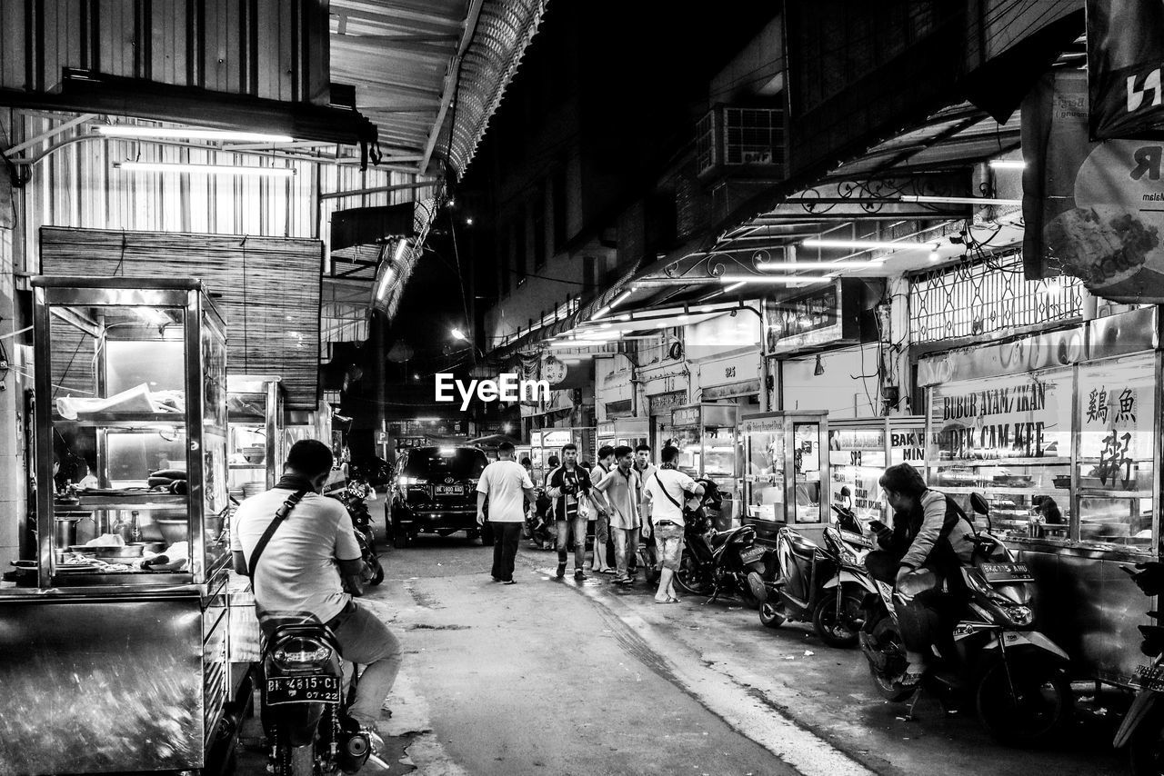 People on street in city at night