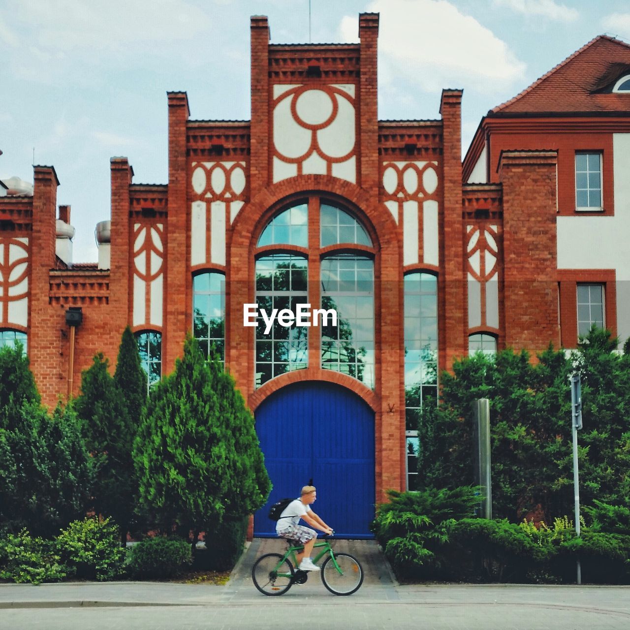 Side-view of young man on bicycle