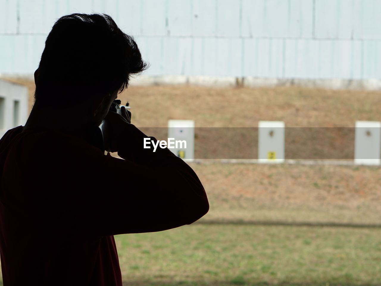 Young man target shooting