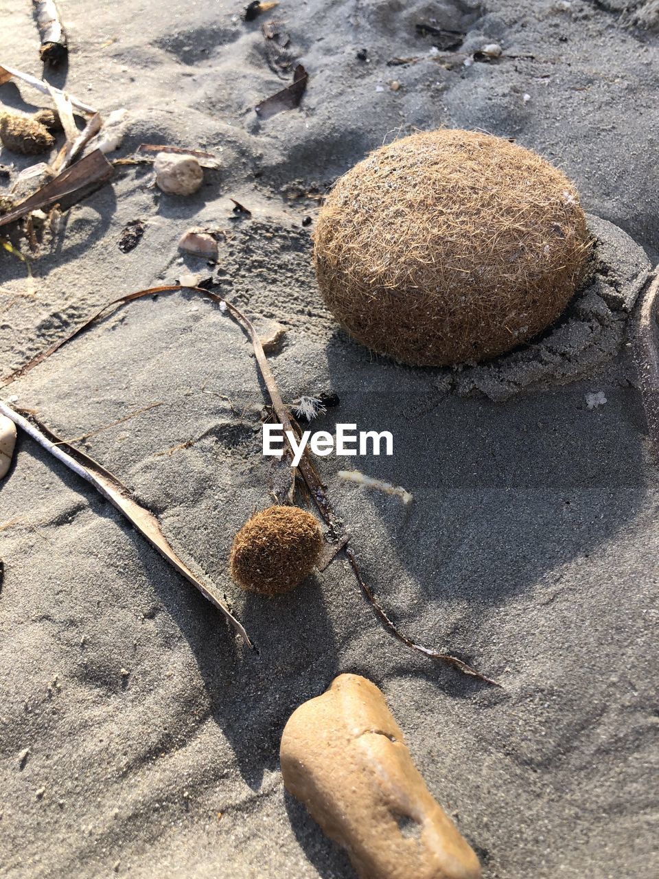 CLOSE-UP OF STONES ON SAND