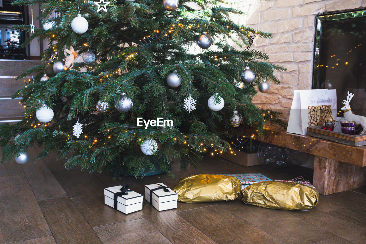 Christmas presents on floor under tree