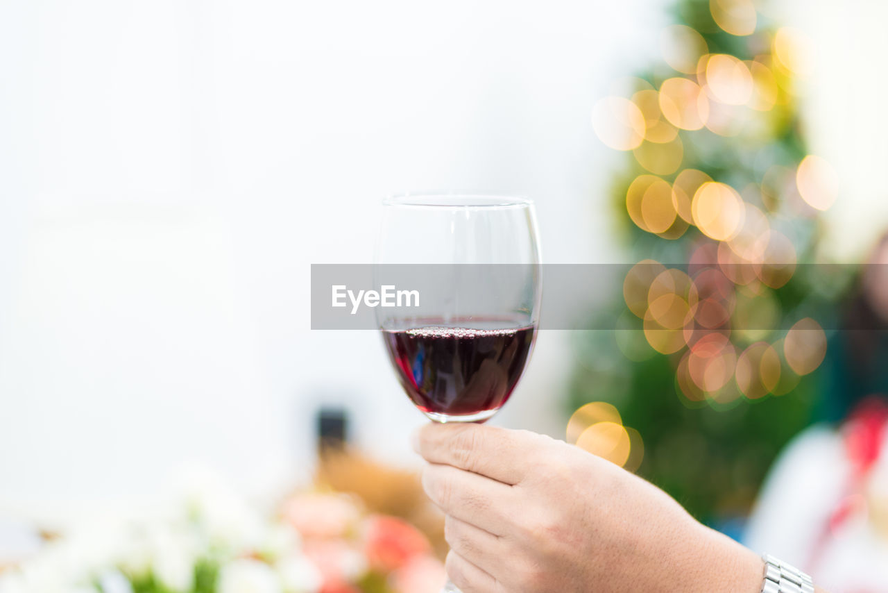 Close-up of hand holding wineglass