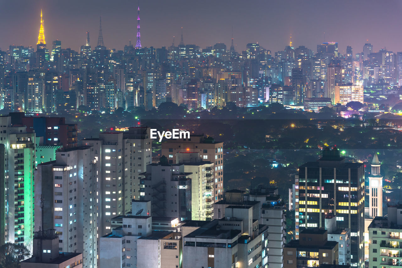 Aerial view of illuminated buildings in city at night