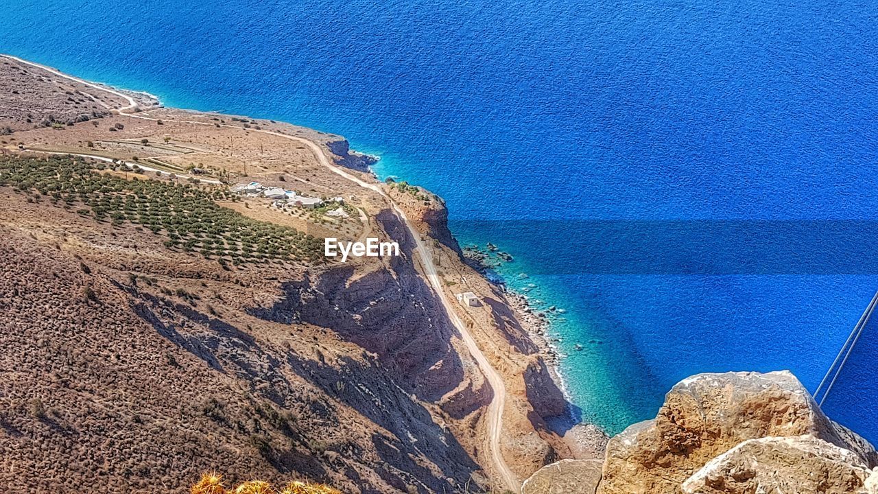 High angle view of cliff by sea