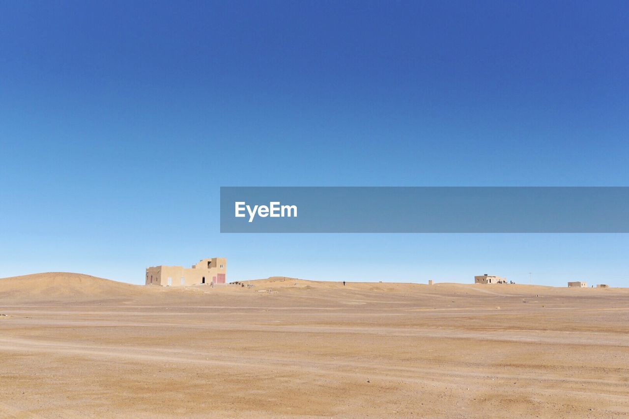 SCENIC VIEW OF DESERT AGAINST BLUE SKY