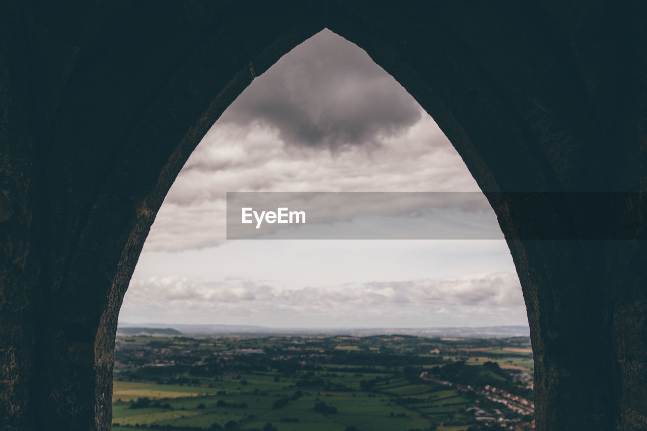 SCENIC VIEW OF MOUNTAINS AGAINST CLOUDY SKY