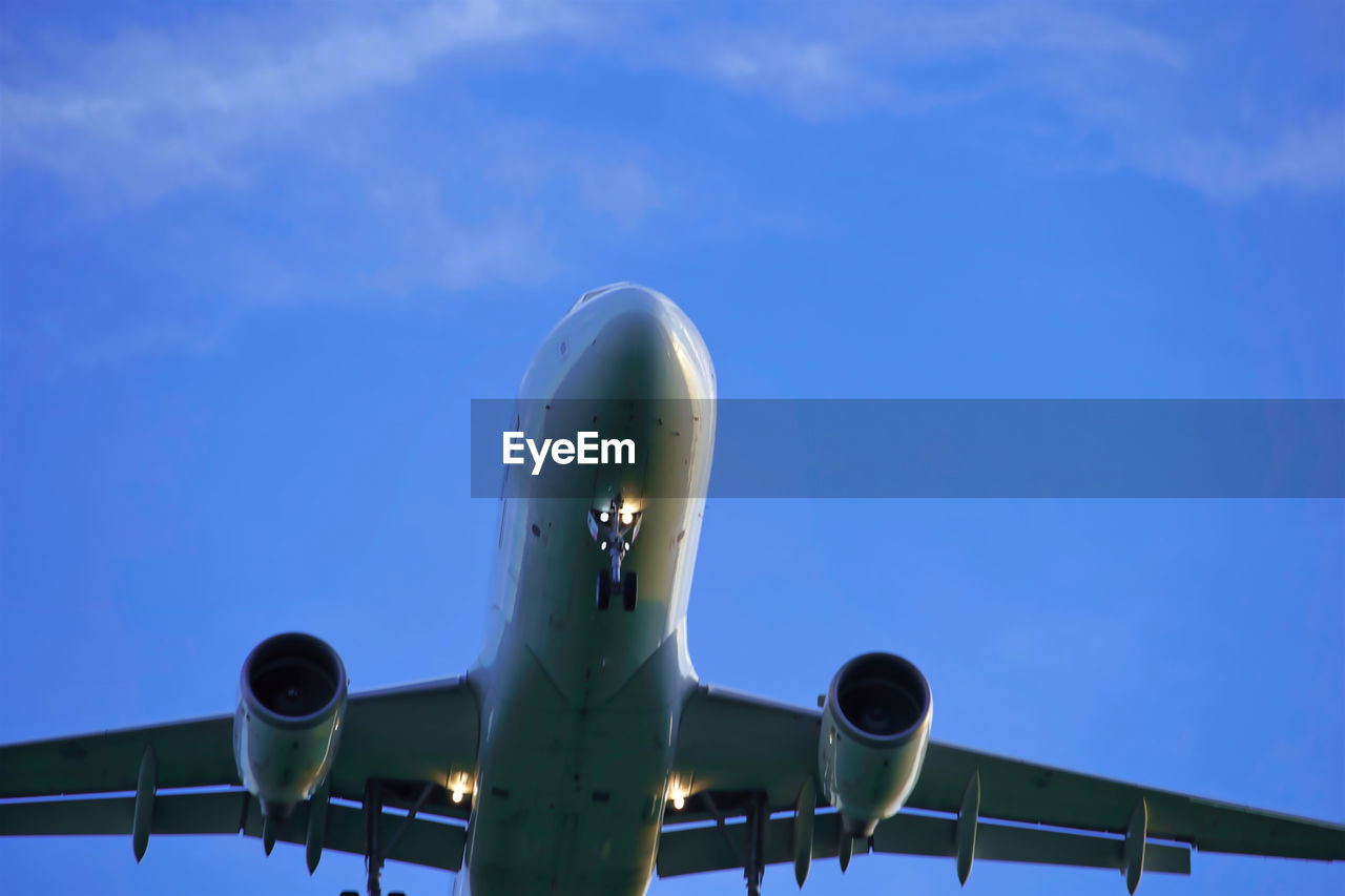 Low angle view of airplane flying against sky