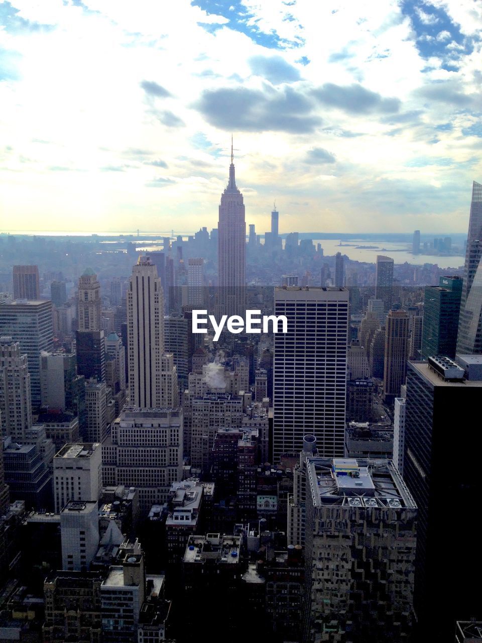 Aerial view of buildings in city against sky