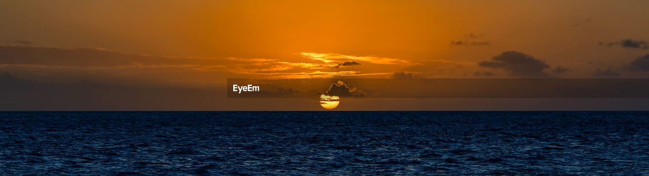 Silhouette boat sailing on sea against sky during sunset