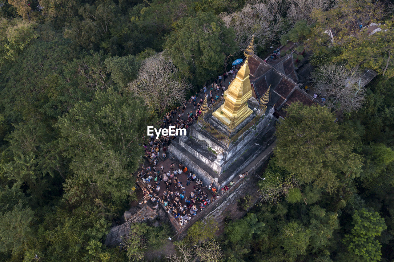 Aerial view of people in temple amidst trees