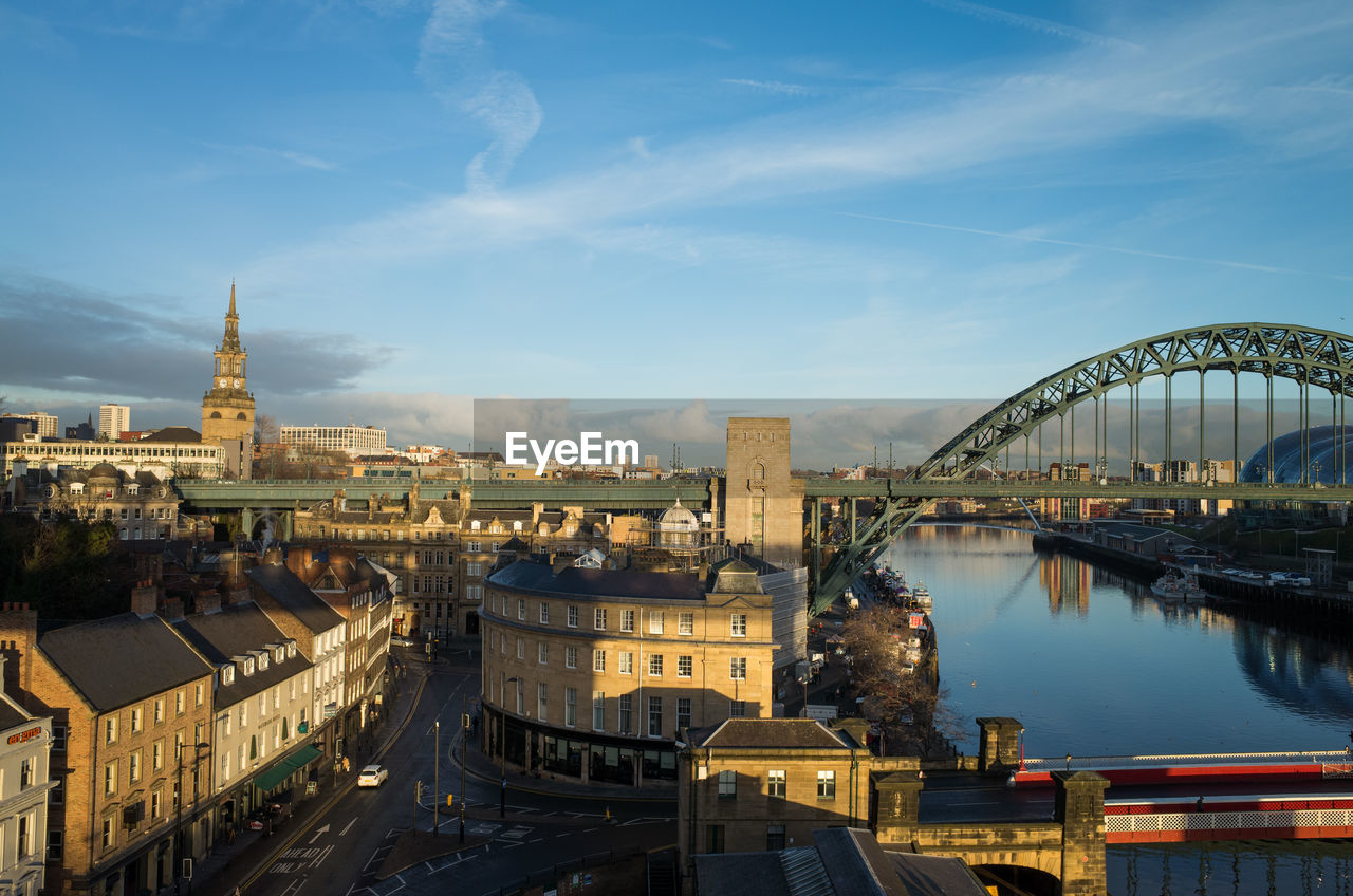 Bridge over river with buildings in background