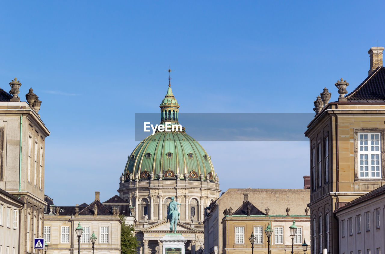 Amalienborg palace with dome of frederik's church and blue sky background