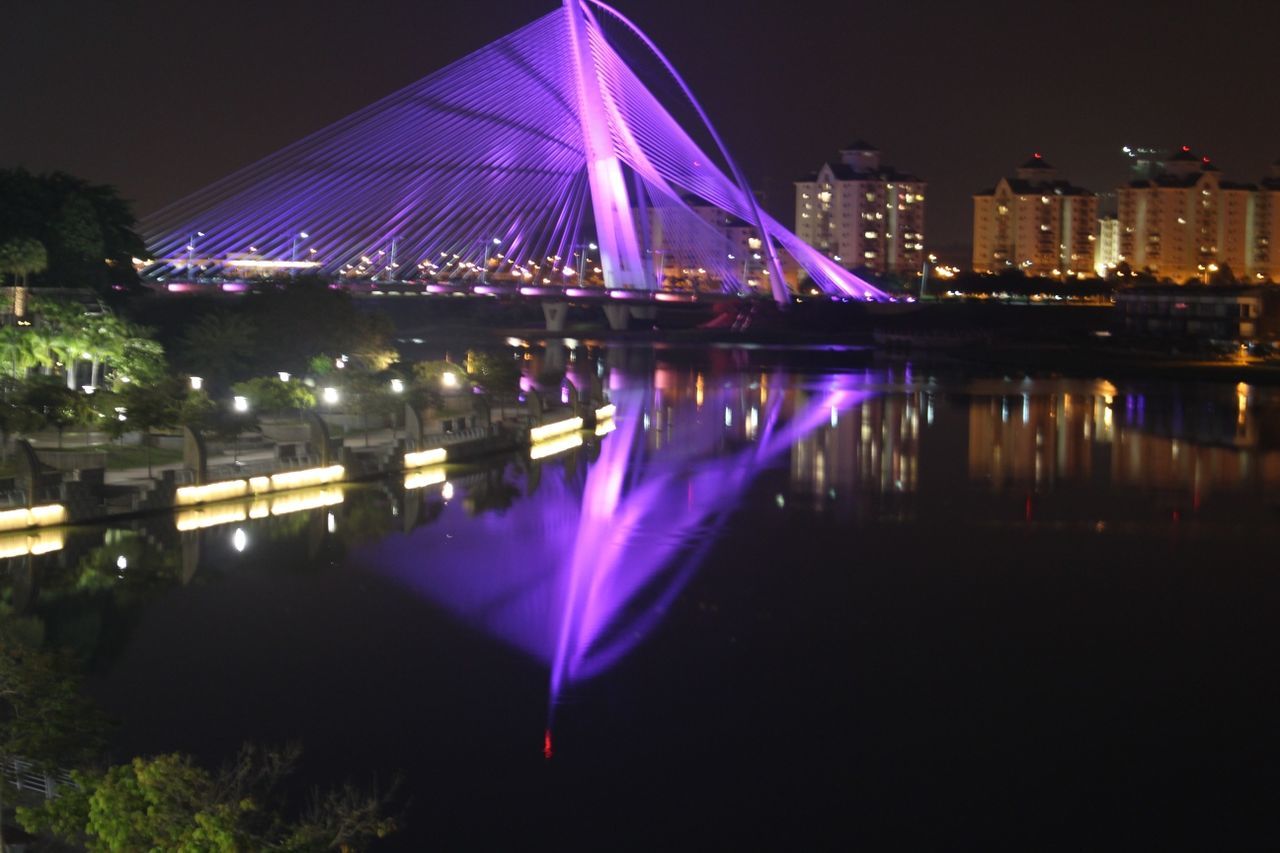 VIEW OF ILLUMINATED CITYSCAPE AT NIGHT