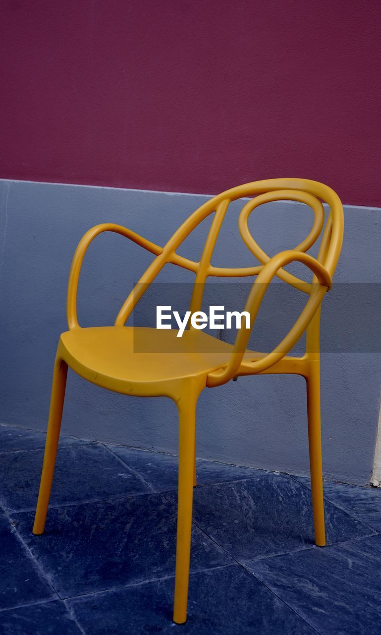 Yellow  chair against blue background bauhaus scenario