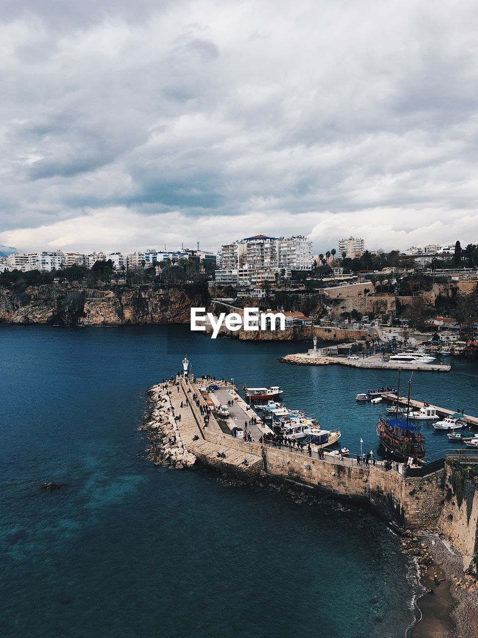 High angle view of buildings by sea against sky