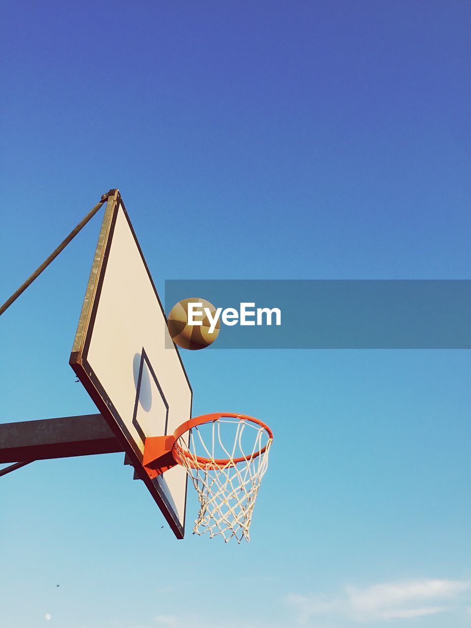 Low angle view of basketball hoop against blue sky