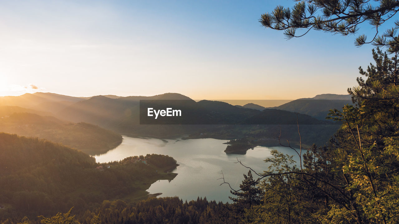 Picturesque landscape view from above on lake and hills at sunset