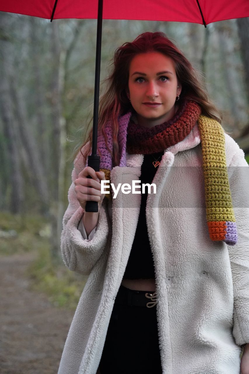 Portrait of young woman holding umbrella