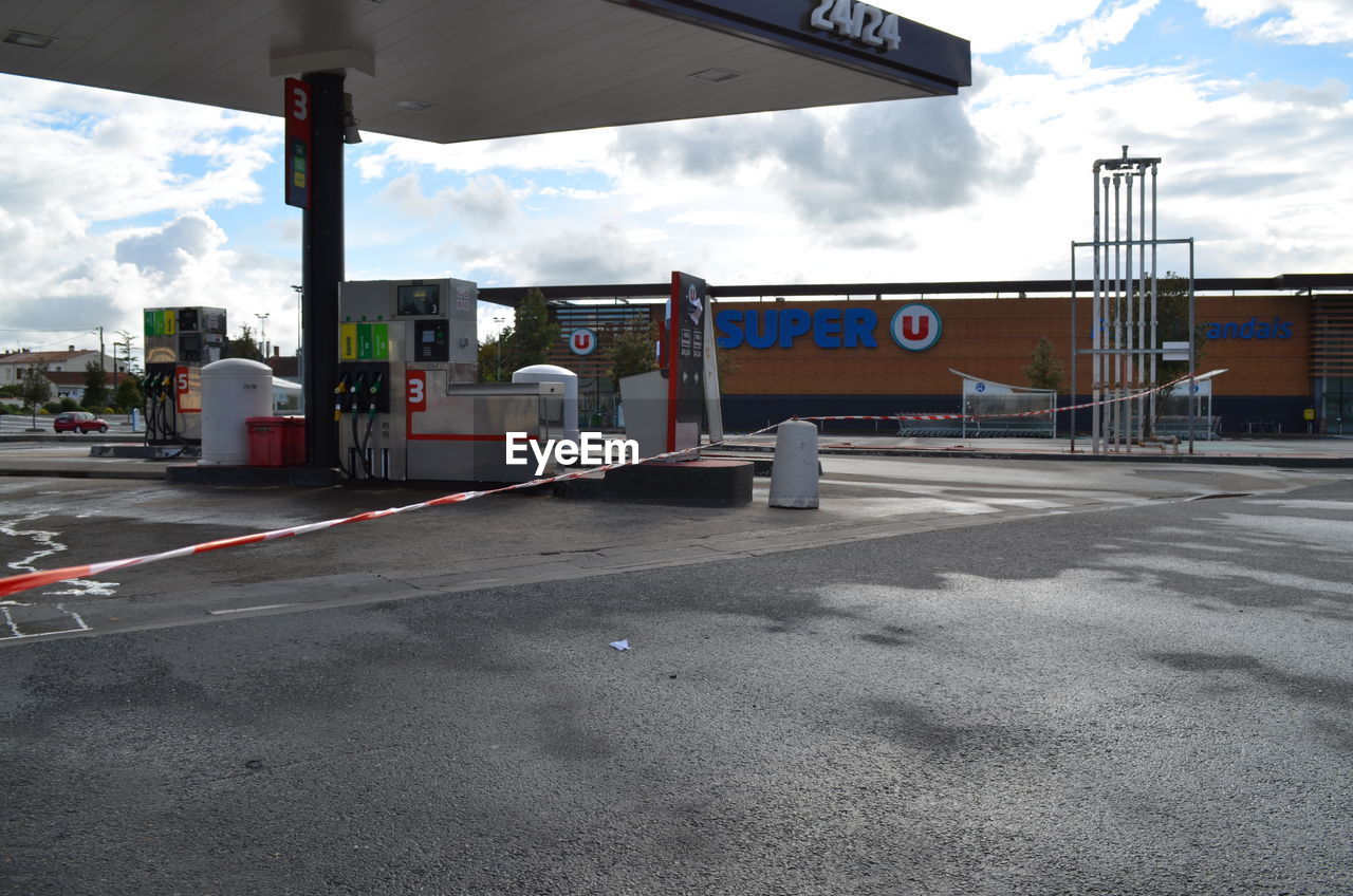 Empty fuel pump against sky