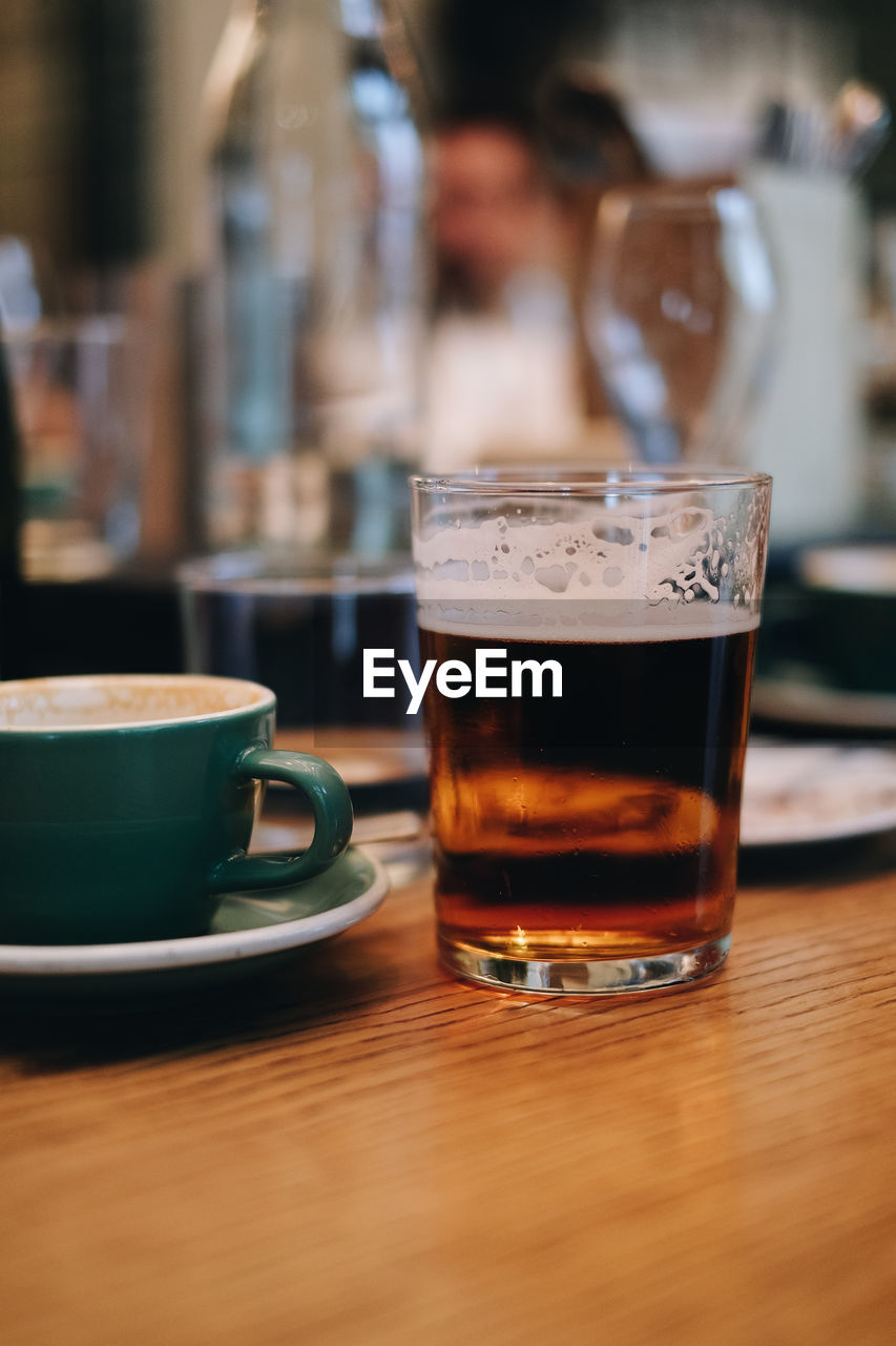 Close-up of coffee and beer on table