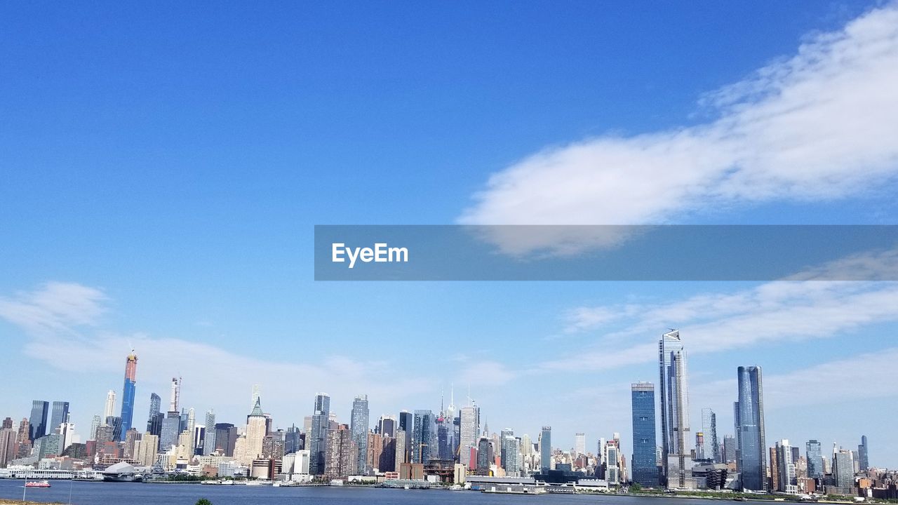 Panoramic view of modern buildings in city against sky