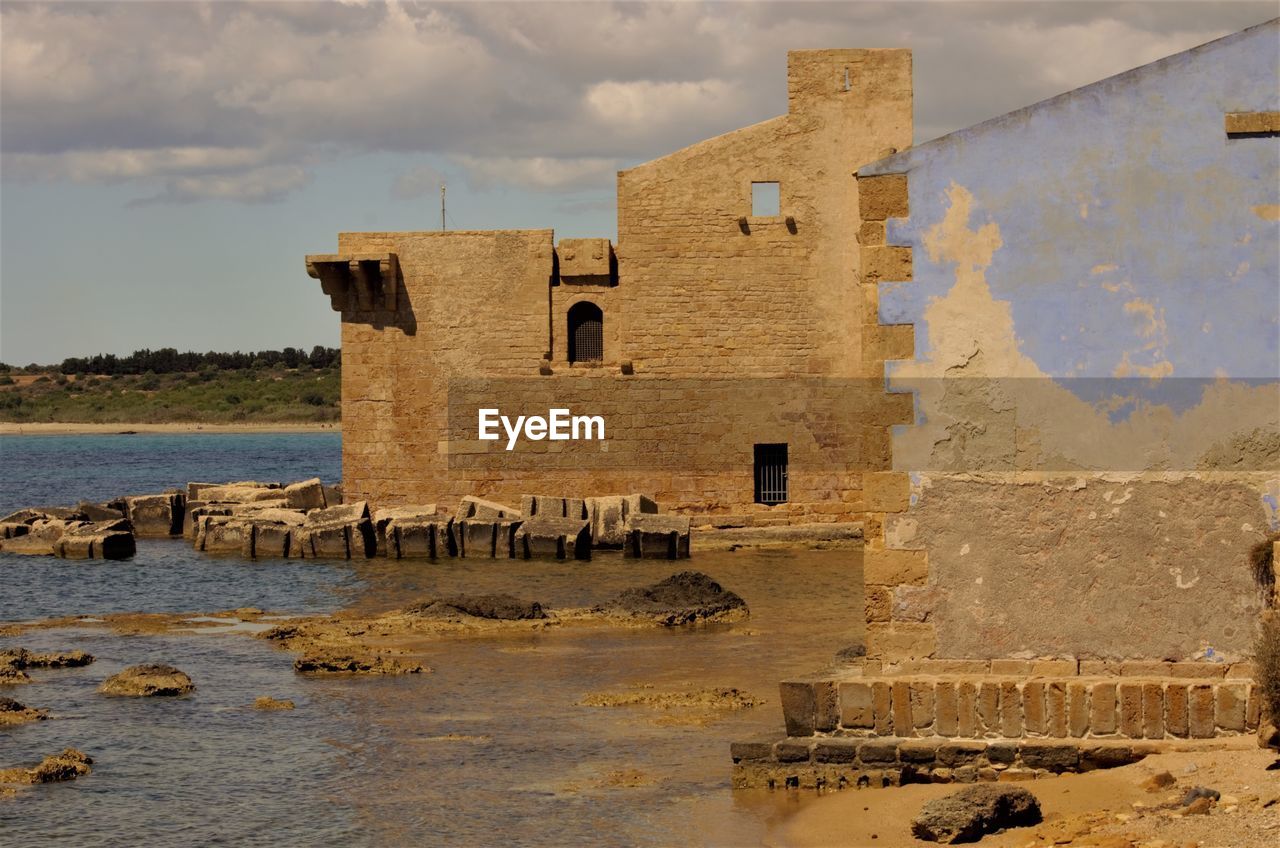 OLD BUILDING BY RIVER