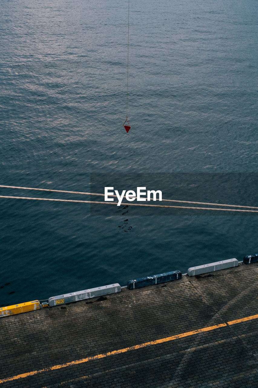 High angle view of boat on road by sea