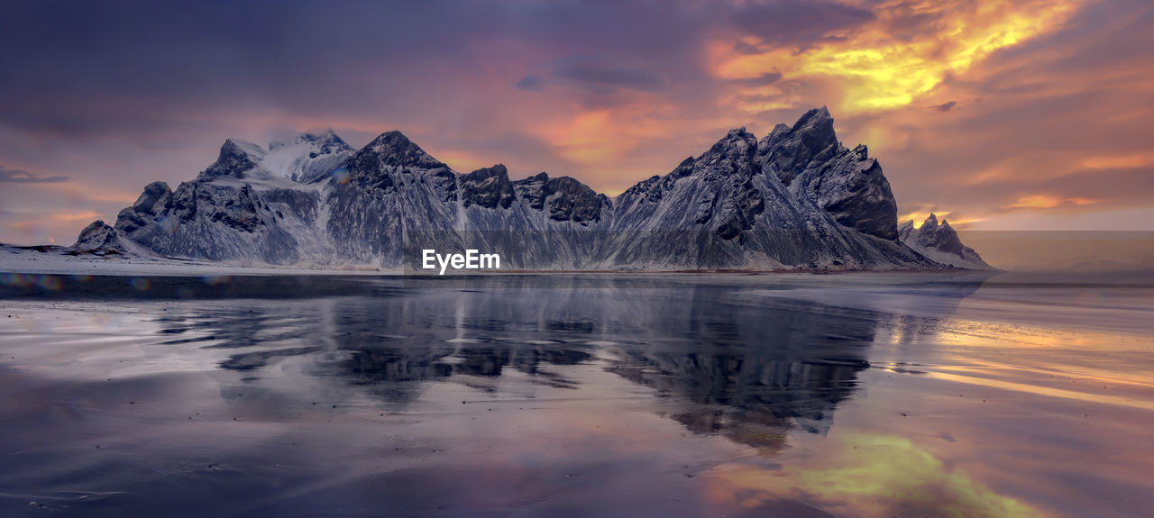 SCENIC VIEW OF LAKE AGAINST SKY DURING SUNSET