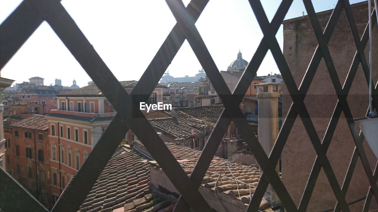BUILDINGS SEEN THROUGH CHAINLINK FENCE