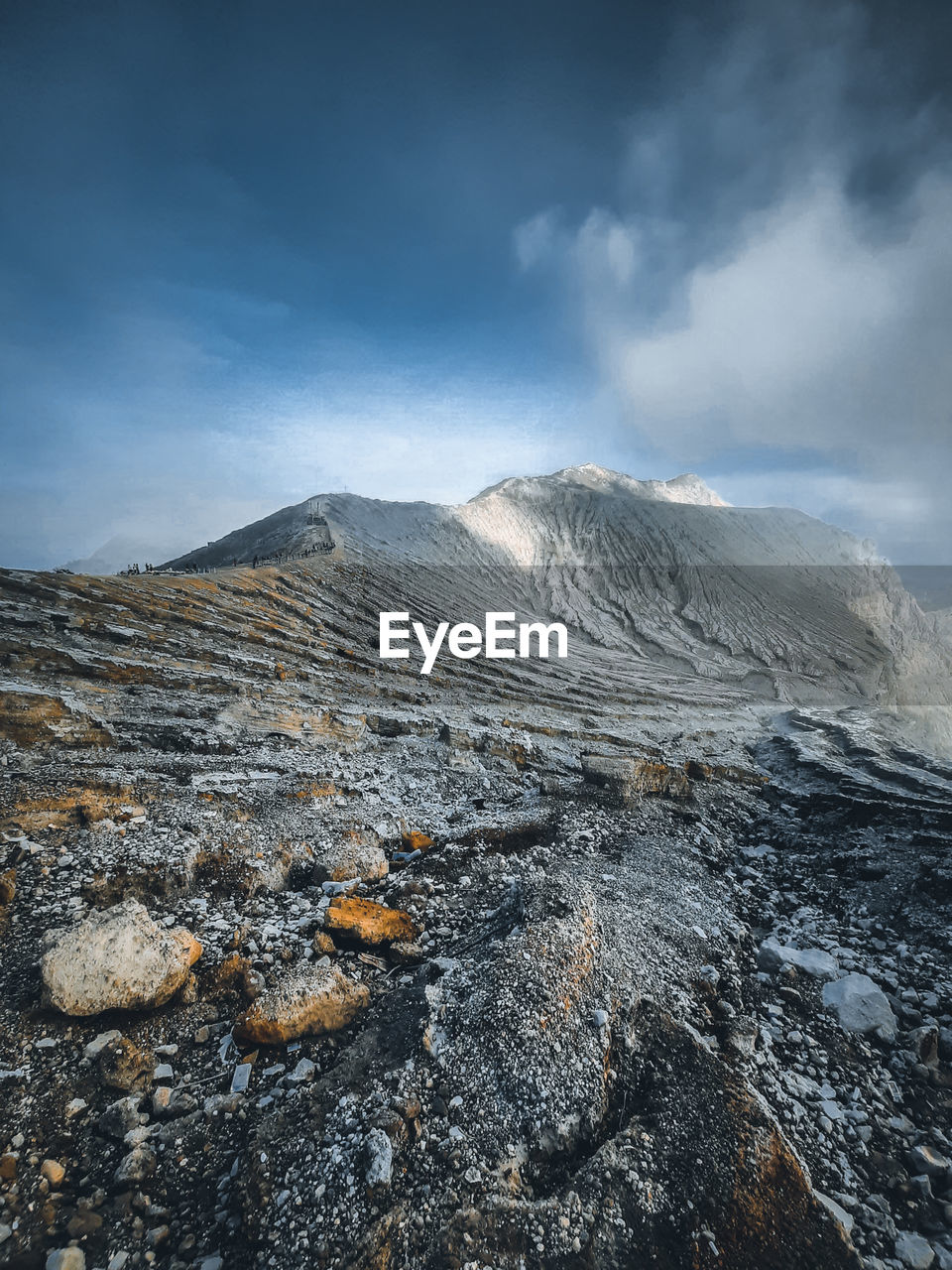 Smoke emitting from volcanic mountain against sky